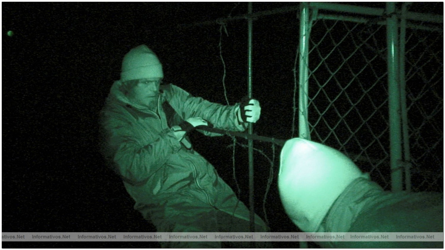 Charles Hambelton climbs the first barrier with Simon Hutchins to gain entrance into the secret cove in Taiji, Japan to place high definition cameras hidden in fake rocks.
